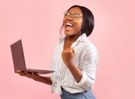 Woman smiling with laptop in hand